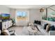 Bright living room with a large window and stylish decor, perfect for relaxing and entertaining at 1218 Alstonia Ln, Mount Dora, FL 32757