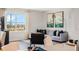 Bright living room featuring large window and stylish decor with gray sofa and modern artwork at 1218 Alstonia Ln, Mount Dora, FL 32757