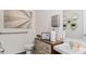 Bright powder room featuring modern vanity, stylish fixtures, decorative wall art and a toilet at 1218 Alstonia Ln, Mount Dora, FL 32757