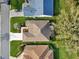 Birds eye view of home with manicured lawns and a screened in lanai at 1309 Carolina Ct, The Villages, FL 32162
