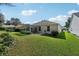 Large backyard featuring a screened-in porch and nicely landscaped yard at 1309 Carolina Ct, The Villages, FL 32162