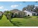 Charming backyard featuring a screened-in porch with plenty of lawn space at 1309 Carolina Ct, The Villages, FL 32162