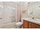 Full bathroom features a shower-tub combination and wood vanity at 1309 Carolina Ct, The Villages, FL 32162