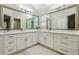 Bathroom vanity with double sinks, large mirrors, and ample storage space at 1309 Carolina Ct, The Villages, FL 32162
