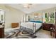 Well-lit bedroom with a metal bed frame, ceiling fan, and two side tables with lamps at 1309 Carolina Ct, The Villages, FL 32162