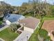 Well-maintained home exterior features a long driveway and mature landscaping at 1309 Carolina Ct, The Villages, FL 32162