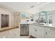 Bright kitchen with stainless steel appliances and white cabinets at 1309 Carolina Ct, The Villages, FL 32162