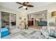 Cozy lanai featuring bright furniture, ceiling fan and an opening into the living room at 1309 Carolina Ct, The Villages, FL 32162