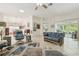 Spacious living room featuring tile floors, ceiling fan, and view into the dining area and lanai at 1309 Carolina Ct, The Villages, FL 32162