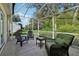 Enclosed patio features comfortable seating and views of the landscaped backyard at 1309 Carolina Ct, The Villages, FL 32162