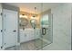 Bathroom featuring glass shower, double vanity, round mirrors and modern fixtures at 1340 Crystal Lake E Ave, Orlando, FL 32806