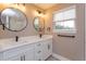 Bathroom with double vanity, modern fixtures, and round mirrors at 1340 Crystal Lake E Ave, Orlando, FL 32806