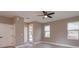 Well-lit bedroom with ceiling fan, closet, and a window with outside views at 1340 Crystal Lake E Ave, Orlando, FL 32806
