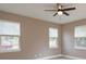 Comfortable bedroom with two windows and a ceiling fan at 1340 Crystal Lake E Ave, Orlando, FL 32806