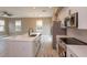 Well-lit kitchen with a kitchen island, stainless steel appliances, and an open-concept floor plan at 1340 Crystal Lake E Ave, Orlando, FL 32806