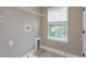 Spacious laundry room area with wire shelving, large window and washer/dryer hookups at 1340 Crystal Lake E Ave, Orlando, FL 32806