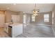 Open-concept living room and kitchen with stainless appliances, white cabinets, and stylish light fixture at 1340 Crystal Lake E Ave, Orlando, FL 32806