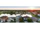 Aerial view of the neighborhood with a lake and houses at sunset at 1430 Clarks Summit Ct, Orlando, FL 32828
