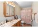 Charming bathroom featuring a framed mirror, a single vanity and toilet with colorful patterned shower curtain at 1430 Clarks Summit Ct, Orlando, FL 32828