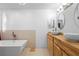 Modern bathroom with a soaking tub, walk in shower and double vessel sinks on a butcher block counter at 1430 Clarks Summit Ct, Orlando, FL 32828