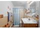A well-lit bathroom featuring a vanity, commode, and walk-in shower at 1430 Clarks Summit Ct, Orlando, FL 32828