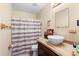Cozy bathroom features a vessel sink on butcher block, toilet and shower with a striped curtain at 1430 Clarks Summit Ct, Orlando, FL 32828