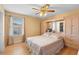 This bedroom features an all-in-one headboard and closet system, ceiling fan and wood-look floors at 1430 Clarks Summit Ct, Orlando, FL 32828