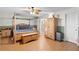 Main bedroom with a four poster bed, wood floors, and a connecting bathroom at 1430 Clarks Summit Ct, Orlando, FL 32828
