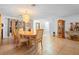 Dining room with tiled floor, chandelier, wood furniture and bright light from windows and door at 1430 Clarks Summit Ct, Orlando, FL 32828