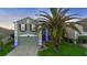 Charming two-story home with a well-manicured lawn, mature palm tree, and welcoming curb appeal at 1430 Clarks Summit Ct, Orlando, FL 32828