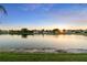 A scenic view of the lake at sunset with the houses visible in the background at 1430 Clarks Summit Ct, Orlando, FL 32828