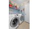 Well-organized laundry room with modern front load washer and dryer at 1430 Clarks Summit Ct, Orlando, FL 32828