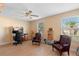 Bright and airy office with hardwood floors, ceiling fan, two chairs and natural light at 1430 Clarks Summit Ct, Orlando, FL 32828