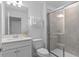 Clean bathroom featuring a single vanity with quartz countertops and a tile shower at 16164 Palm Frond Ave, Clermont, FL 34714