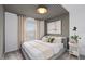 Comfortable bedroom with stylish accent wall, carpet floors, and natural lighting at 16164 Palm Frond Ave, Clermont, FL 34714