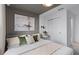 Inviting bedroom featuring carpet, a stylish accent wall, and a serene atmosphere at 16164 Palm Frond Ave, Clermont, FL 34714