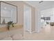 Stylish entryway featuring a decorative mirror, neutral tones, and an open layout at 16164 Palm Frond Ave, Clermont, FL 34714
