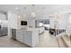 Bright, open-concept kitchen featuring a large island, stainless steel appliances, and seamless flow to living and dining areas at 16164 Palm Frond Ave, Clermont, FL 34714