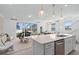 Open-concept living space with a large island, seamless flow to the living area and outdoor patio at 16164 Palm Frond Ave, Clermont, FL 34714