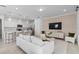 Open-concept living space featuring a modern kitchen, living area with stylish decor, and seamless design at 16164 Palm Frond Ave, Clermont, FL 34714