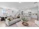 Open-concept living space with a modern kitchen, comfortable seating, and stylish decor at 16164 Palm Frond Ave, Clermont, FL 34714
