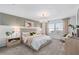 Sun-filled main bedroom boasting carpet floors, pendant lighting, and a seating area at 16164 Palm Frond Ave, Clermont, FL 34714