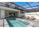 Backyard pool area with lounge chairs and outdoor dining, perfect for relaxation and entertaining guests at 16164 Palm Frond Ave, Clermont, FL 34714