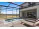 Outdoor pool with screened enclosure, lounge chairs and backyard view for relaxed, outdoor living at 16164 Palm Frond Ave, Clermont, FL 34714