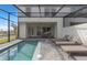 Pool with outdoor lounge area, ideal for relaxation with a covered patio and backyard view at 16164 Palm Frond Ave, Clermont, FL 34714