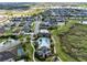 Aerial view showcases the community pool, manicured landscaping, and well-maintained homes in the neighborhood at 1675 Amsel Falls Park Ter, Winter Garden, FL 34787