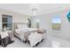 Bright bedroom featuring a large bed, natural light, and neutral decor at 1675 Amsel Falls Park Ter, Winter Garden, FL 34787