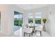 Bright breakfast nook featuring a round table, white chairs, and a view of the backyard at 1675 Amsel Falls Park Ter, Winter Garden, FL 34787