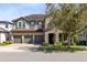 Charming two-story home with stone accents, three-car garage, and meticulously maintained landscaping at 1675 Amsel Falls Park Ter, Winter Garden, FL 34787