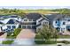 Beautiful two-story home with a three-car garage and brick paved driveway near a lake at 1675 Amsel Falls Park Ter, Winter Garden, FL 34787